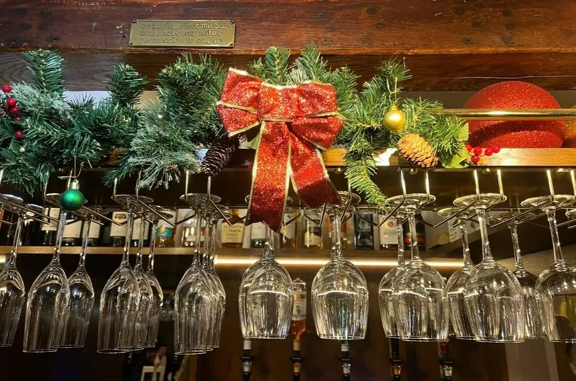 Wine glasses and festive decorations at the bar